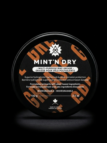 Mint 'N Dry multi-purpose bike grease container on a black background