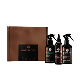 Three 'Mint N Dry' spray bottles in front of a brown box on a white background